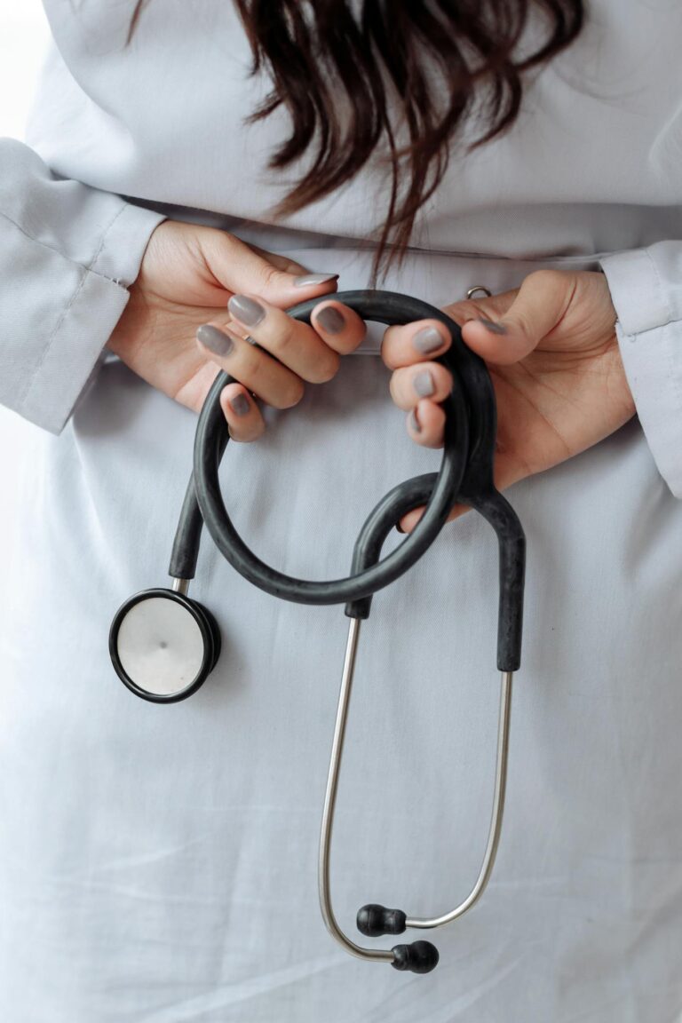 Hands with Gray Nail Polish on Her Fingers while Holding Stethoscope
